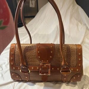 brown leather handbag with gold studs and buckle